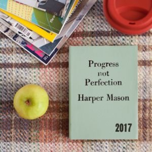 progress not perfection book on table with apple
